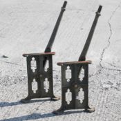 A pair of cast iron bench ends from a tram or rail carriage with reversible backrest and pierced
