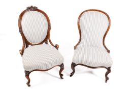 Two Victorian carved walnut framed ladies chairs with matching upholstery.