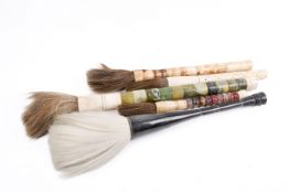 A group of five assorted Chinese calligraphy brushes. Made up of hard stone or bone.