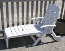 A Hartman white plastic garden patio sun lounger.