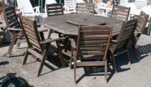 A Clarecraft hardwood nine-piece garden suite of furniture.