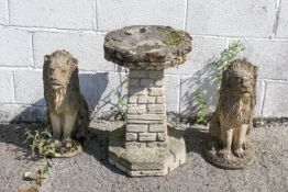A pair of reconstituted stone garden seated lions and bird bath.
