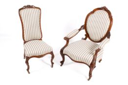 Two Victorian carved walnut framed chairs with matching upholstery.