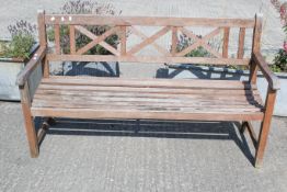 A teak slatted garden bench.