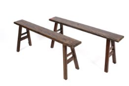 A pair of 20th century stained pine wooden benches. With splayed legs united by two stretchers.