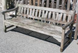 A vintage three-seater slatted teak garden bench.
