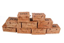A group of nine hampers with black stenciled 'F&M' to the top for Fortnum and Mason.