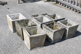 A group of nine reconstituted stone square planters.
