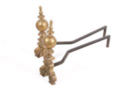 A pair of brass andirons firedogs with ball finials and ornate base.