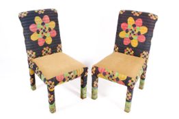 Two modern floral upholstered high back side chairs.