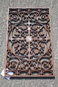 A contemporary cast metal door mat.