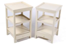 A pair of contemporary neutral cream OKA side tables with single drawer and shelf.