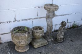Two reconstituted stone garden planters, a bird bath and a fish fountain head.