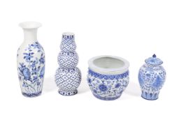 A group of four blue and white china items.