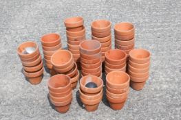 A collection of small terracotta plant pots.