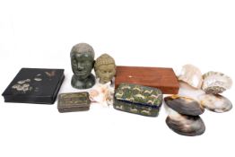 A group of assorted collectables. Including sea shells, boxes and carved stone heads, etc.