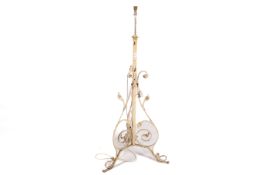 A white painted wrought iron standard lamp with scrolling supports,