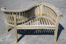 A Teakunique hardwood garden love seat bench.