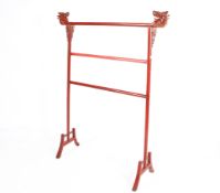 A Chinese red lacquered wooden clothing rail with dragon motifs.