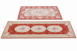 A 20th Century French Abusson style red ground rug along with a similar style runner,
