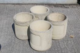 Four matching 20th century Cotswold Studios Ltd deep weathered stone garden planters.