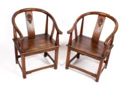 A pair of 20th century Chinese Ming style hardwood chairs.