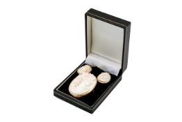 A cameo brooch and pendant earrings.