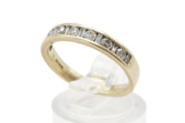 A hallmarked 9ct gold half eternity ring. Set with mixed cut diamonds of 0.