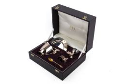 An Asprey & Garrard silver and white metal christening set, cased.