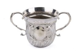 An early 18th century twin-handled silver cup. With scroll handles, wave-like vertical ribbing.
