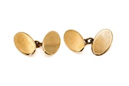 A pair of 9ct gold cufflinks. Of oval, undecorated form, gross weight 8.2g.
