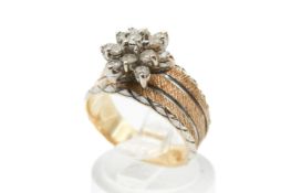 A yellow metal and diamond cluster ring. Set with round brilliant cut diamonds of 0.