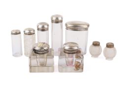 A group of vintage silver topped bottles and ink wells.