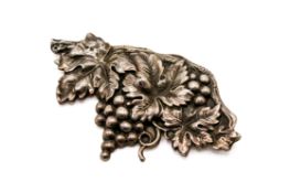 A white metal brooch in the form of grapes and vine leaves. Unmarked, circa 7.3cm x 4.