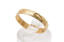 An 18ct gold ring. With textured decoration to the band, width 3.5mm, hallmarked, size ), weight 2.