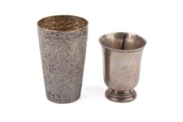 A Cartier silver beaker and a Persian white metal beaker.