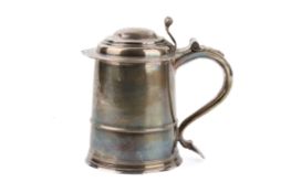 An early 18th century large silver tankard.