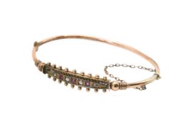 A 9ct gold Etruscan style bangle.