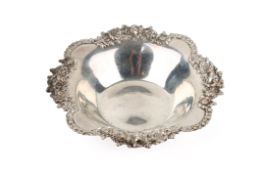 A white metal silver dish stamped 'Stirling'. Having lobed and ornate floral rim.