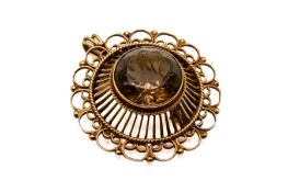 A 19th century 9ct gold and smoky quartz brooch. The faceted round cut stone circa 1.
