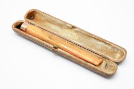A 9ct gold mounted long cheroot, with box. The mount hallmarked, length 12.