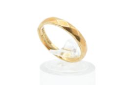 An 18ct gold wedding band. with diamond shaped details, hallmarked, weight 3.4g.