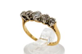 An 18ct gold five stone diamond ring. The largest round cut stone circa 0.