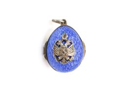 A Russian style white metal and guilloche enamel egg shaped pendant locket.