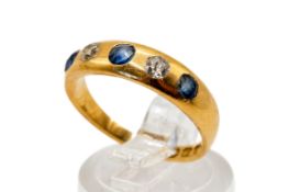 An 18ct gold dress ring. Set with small blue and white stones, hallmarked, size O, gross weight 3.