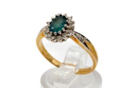 A 9ct gold cluster ring. Set with one oval faceted topaz and round brilliant cut diamonds of 0.