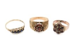 Three stone set yellow metal rings.