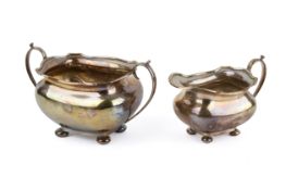 An early 20th century matching silver sugar bowl and cream jug.