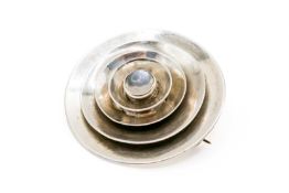 A round flower form silver brooch.