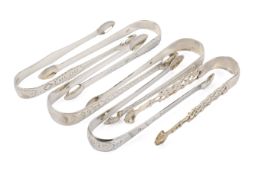 Six Georgian silver sugar tongs.
